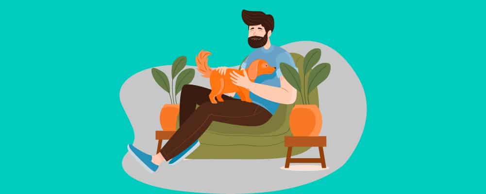 Man petting his dog on a couch