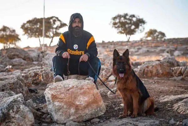 german-shepherd-sitting-with-owner