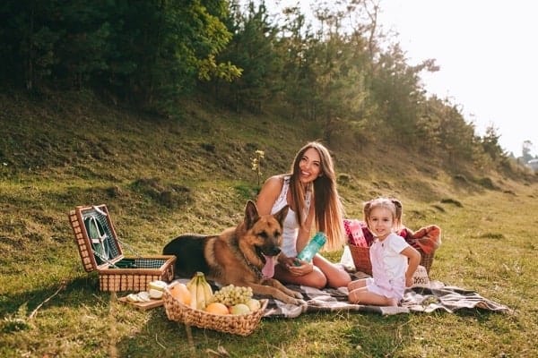 german-shepherd-sitting-with-family-outdoors